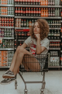person sitting in a grocery cart